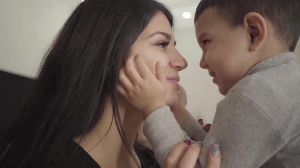 Close-up of a Smiling Middle Eastern Woman and Boy Rubbing Noses. Happy Mother and Son Expressing