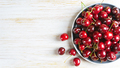 Fresh Red Ripe Sweet Cherry On Plate On White Wooden Background. - PhotoDune Item for Sale
