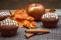 Chocolate muffins with apple filling on a background of autumn leaves and cinnamon - PhotoDune Item for Sale