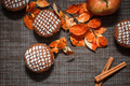 Chocolate muffins with apple filling on a background of autumn leaves and cinnamon - PhotoDune Item for Sale