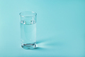 Glass of clear water on a blue background. Health concept. - PhotoDune Item for Sale