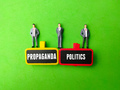Miniature people and wooden board with the word PROPAGANDA POLITICS - PhotoDune Item for Sale