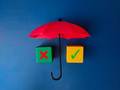 Red umbrella and colored cube with sign wrong and right on blue background. - PhotoDune Item for Sale