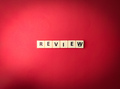 Toys word with the word REVIEW on red background - PhotoDune Item for Sale