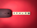 Toys word and wireless mouse with the word REVIEW on red background - PhotoDune Item for Sale