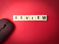 Toys word and wireless mouse with the word REVIEW on red background - PhotoDune Item for Sale