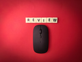 Toys word and wireless mouse with the word REVIEW on red background - PhotoDune Item for Sale