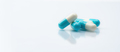 Blue-white capsule pills on white background. Pharmacy banner. Prescription drug. Healthcare  - PhotoDune Item for Sale