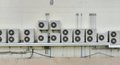 Many condensing units of air conditioners are installed on concrete building wall. Air conditioner - PhotoDune Item for Sale