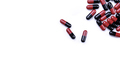 Top view red-black antibiotic capsule pills on white background. Prescription drug. Antibiotic drug - PhotoDune Item for Sale