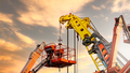 Articulated boom lift. Aerial platform lift and construction crane with sunset sky. Mobile crane - PhotoDune Item for Sale