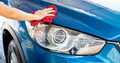 Car wash service. Man hand holding red microfiber cloth polish blue car and water drop after clean - PhotoDune Item for Sale