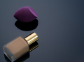 Purple makeup sponge on dark background. Soft makeup cosmetic sponge. Flat-ended makeup sponge - PhotoDune Item for Sale