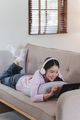 Attractive Asian woman resting comfortable living room and using digital tablet, Relax, Sofa - PhotoDune Item for Sale