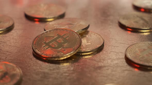 Bitcoin Coins Are Closeup Rotating on a Gold Table