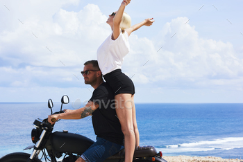 Joyful couple satisfied with riding trip moving on ocean coastline excite with weekend