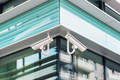 Two modern cctv security cameras on modern building facade - PhotoDune Item for Sale