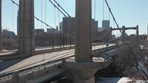 camera going backwards from a bridge at downtown Minneapolis during a sunny afternoon