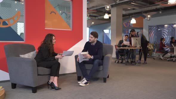 Woman and man talking at a company