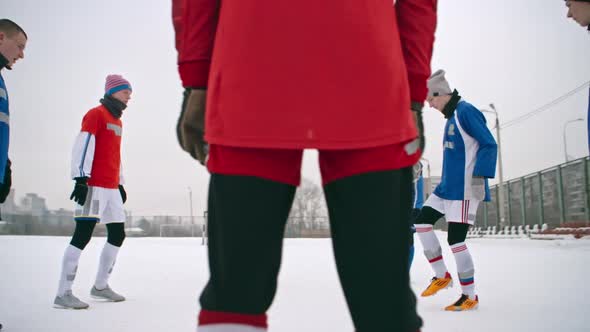 Soccer Players Juggling a Ball