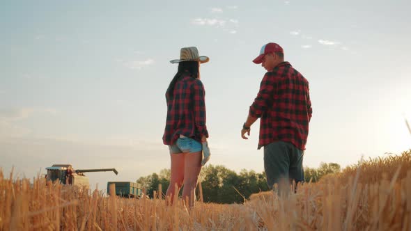 Farmers Handshake Over the Wheat Crop in Harvest Time. Team Farmers Stand in a Wheat Field with