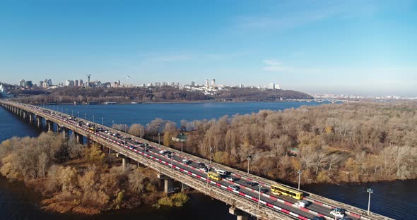 Aerial View of Traffic Jam on a Car Bridge and Moving Train