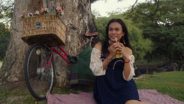 Transgender Asian Woman Standing with Her Bike and Looking at the Camera