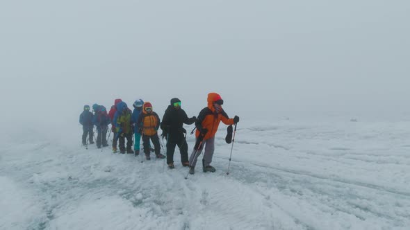 Group of climbers ascend snowy mountain