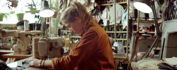 Portrait of Young Woman at Desk in Shoemakers Workshop