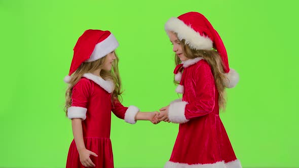 Baby Girls in Red Suits Play Games, Smile and Have Fun, Green Screen