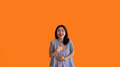 Asian woman laughing happily on orange background, Happiness through laughter - PhotoDune Item for Sale