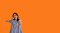 Bright young asian woman inviting to call isolated on orange background - PhotoDune Item for Sale