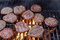 Grilled American beef burger barbecued on a hot grill over a flame - PhotoDune Item for Sale
