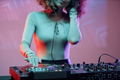 Female DJ making music tracks at night party in neon light - PhotoDune Item for Sale