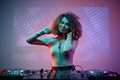 Portrait of young woman as female DJ looking at camera - PhotoDune Item for Sale
