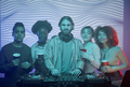 DJ with diverse group of people taking photo in nightclub - PhotoDune Item for Sale