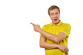 Surprised guy with funny face in yellow T-shirt pointing finger to left, white background - PhotoDune Item for Sale