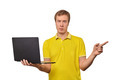 Puzzled young man with laptop pointing with finger isolated on white background, male confused face - PhotoDune Item for Sale
