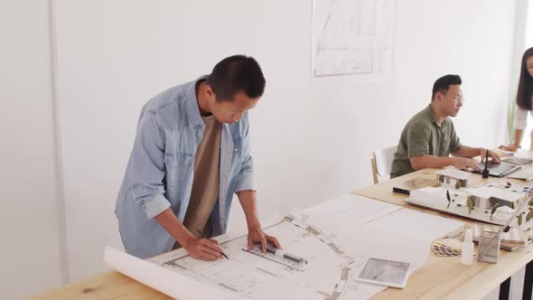 Asian Male Architect Drawing House Plan