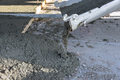 A concrete mixing truck pours concrete for the surrounding pavement of the newly constructed home on - PhotoDune Item for Sale