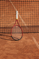 tennis racket is at net tennis court made of red clay soil with markings for game or competition - PhotoDune Item for Sale