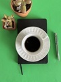 Coffee on top of notebook on green background  - PhotoDune Item for Sale