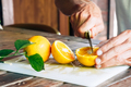 Male hands cutting juicy ripe orange fruit and sharing it with son. - PhotoDune Item for Sale