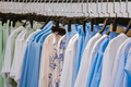 A lot of beautiful clothes hanging on hangers. Clothing rental concept. - PhotoDune Item for Sale