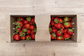 Fresh strawberries in a cardboard basket lying on a wooden table. - PhotoDune Item for Sale