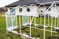 Assembling a home greenhouse from an aluminum frame and thick foil. - PhotoDune Item for Sale