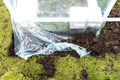 Assembling a home greenhouse from an aluminum frame and thick foil. - PhotoDune Item for Sale