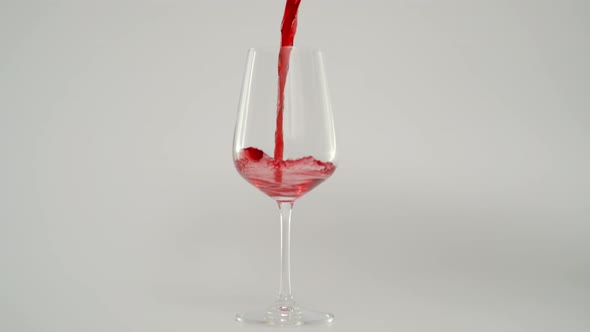 Slow Motion of Pouring Red Wine in Glass at 1000 Fps Red Background