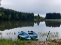 Two wooden boats and a lake surrounded by forest of coniferous trees on a cloudy summer day - PhotoDune Item for Sale