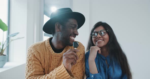 Couple receiving new car keys smiling